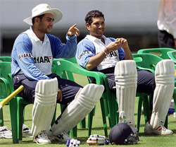 Virendar Sehwag speaks to teammate Sachin Tendulkar