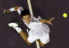 British Tim Henman serves to Thailand's Paradorn Srichaphan