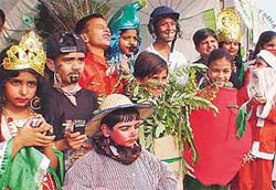 Children in colourful attire wait for their turn to participate in a fancy dress show