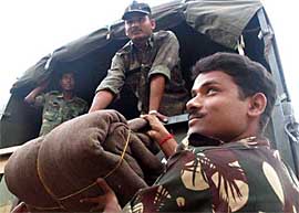 A soldier unloads his baggage