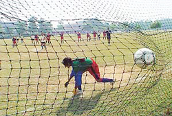 Goalkeeper of the Dev Samaj College of Women, Sector 45, fails to save a goal 