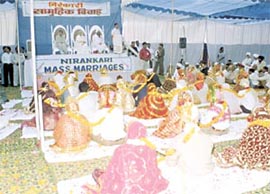 Nirankari Baba Hardev Singhji Mahnaraj, his mother and spouse blessing the 25 couples who tied the knot at a simple ceremony