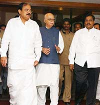 Deputy Prime Minister L.K. Advani arrives with BJP President Venkaiah Naidu and Mumbai unit president Vinod Tawde to address a meeting of district presidents and Central office-bearers in Mumbai on Sunday.