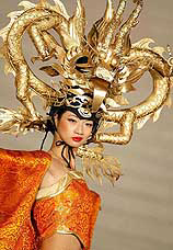 A Chinese model displays a hat in the shape of a dragon