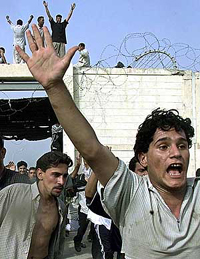 Relatives of prisoners run inside of the Abu Kreeb prison