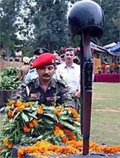 An Army officer lays wreath