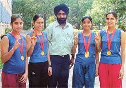 Players of the GCW, Ludhiana, with their coach, who won the inter-college cross-country meet held by Panjab University