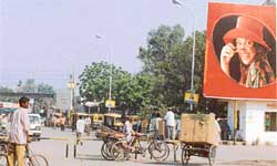 A rickshaw-puller carries a parcel from the the railway station to evade sales tax 