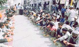 Devotees partake of food at a "langar" organised by the Maharishi Valmiki Naujwan Sabha at Bhadaur House