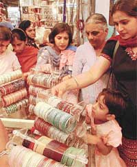 A young woman selects "Devdas" bangles, which are in great demand
