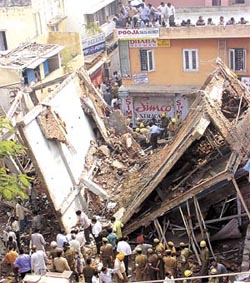 Rescue workers trying to extricate those trapped in the debris of the three-storey building, which collapsed in Punjabi Bagh