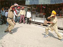 This is not a lathi charge, but a policeman plays traditional 'gatka'