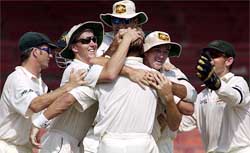 The Australian team celebrates after taking the last Pakistan wicket at Sharjah Cricket Stadium 