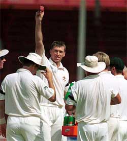 Australian fast bowler Glenn McGrath acknowledges the crowd with the ball after getting 400 wickets in Test cricket