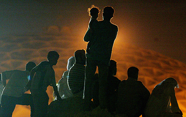 Supporters watch a television screen