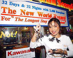 Kanchana Ketkeaw, a 30-year-old Thai woman, celebrates with scorpions