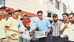 Singer-actor Harbhajan Mann presents gift to a subscriber of The Tribune on Thursday. 