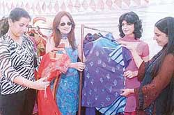 Visitors look at designer wear on display at the two-day exhibition organised at the Lakshmi Ladies Club