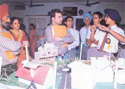 Students explain the working of a model at a science exhibition held at Joseph�s School