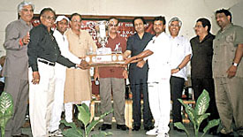 Sonnet Club captain Davender Sharma receiving the Dr Goswami Girdhari Lal Memorial Cricket Trophy from DDCA sports secretary Sunil Dev