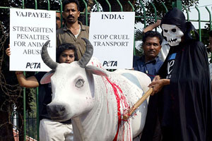 A man wearing a death mask beats a statue