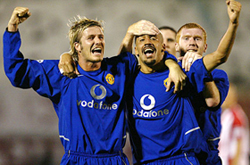 Scorer of the second goal for Manchester United FC Juan Veron celebrates with team mates