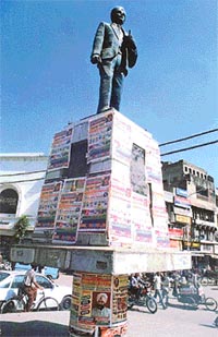 A statue of Kartar Singh Sarabha covered with posters in Ludhiana