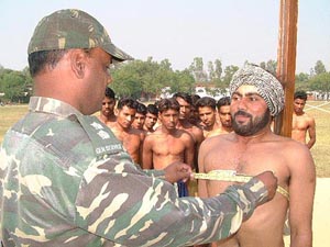 An Army official of the Sikh Light Infantry conducts physical test