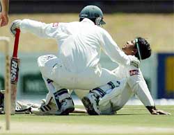 Bangladesh batsman Hannan Sarkar is consoled by team-mate Al Sahariar, after he was struck by a bouncer in the second cricket Test between South Africa and Bangladesh