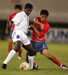 India's Naduparampil P. Pradeep vies for ball with Lee Jong Min of South Korea, right, during their match in AFC U-20