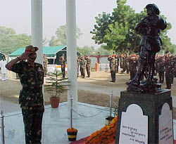 An Army official pays homage to the martyrs