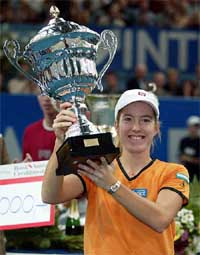 Justine Henin of Belgium holds the winner's cup
