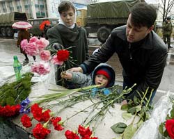 People lay flowers near a theatre in Moscow on Sunday
