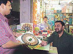 A shopkeeper shows fancy lights to a customer in a city market in Ludhiana
