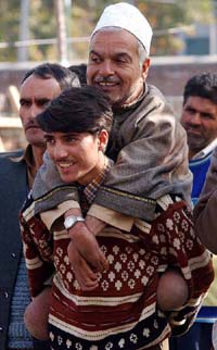 An enthusiastic Congress supporter carries his father
