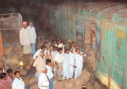 Punjab minister Chowdhary Jagjit Singh hands over wheat bags to Rajasthan officials and others at Bikaner (Rajasthan) on Tuesday night.