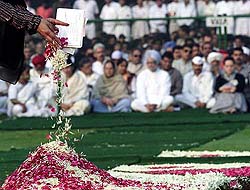 A Congress worker pays floral tribute