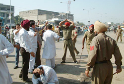 The police lathi charge on a group of irate shopkeepers