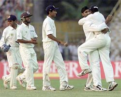 India's captain Sourav Ganguly celebrates with Harbhjan Singh