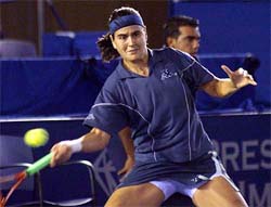 Conchita Martinez of Spain returns a shot to Patricia Wartusch