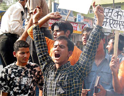 Protesters shout slogans against Congress President Sonia Gandhi
