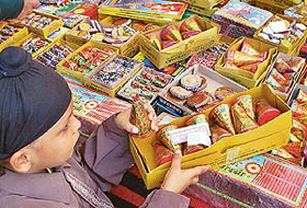 A boy chooses crackers on the eve of Divali, in Sector 22, Chandigarh, on Sunday.