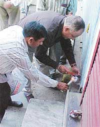 Officials of the MC seal a shop as part of a drive to remove encroachments and enforce building and land use bylaws
