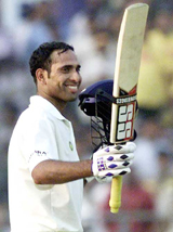 Indian batsman V.V.S. Laxman acknowledges the crowd after scoring 150 runs during the fifth day's play of the third test match between India and West Indies in Calcutta on Sunday.