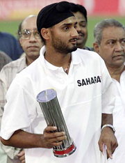 Harbhajan Singh holds the Man of the Series trophy