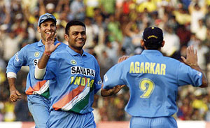 Indian bowler Virender Sehwag (C) celebrates with team mates Yuvraj Singh (L) and Ajit Agarkar (R) after dismissing West Indies captain Carl Hooper ( not in picture) 