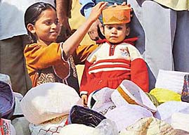 Tabbasum chooses a cap for her brother, Rashid, on the second day of Ramzan at the Sector 20 mosque in Chandigarh 