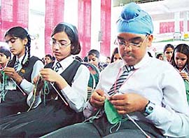 Kids participate in a knitting contest organised by Vardhman Spinning and General Mills at DC Model Senior Secondary School, Sector 7, Panchkula