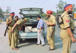 Policemen search a vehicle near Doraha. Special nakkas have been erected on the GT Road