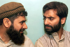 Mohammed Yasin Malik (R), head of the Jammu Kashmir Liberation Front, talks to a comrade